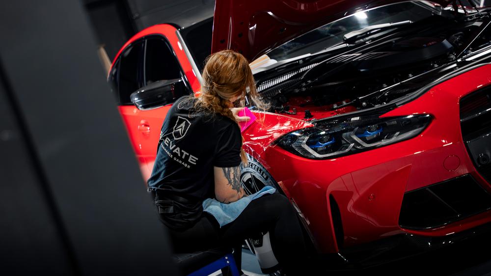 Squeegee work on a BMW M3 Competition door panel during PPF installation